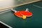 Table Tennis Rackets and Ball on Table with Net