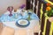 Table on the terrace with soft drinks, flowers and a plate of daisies