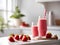 On the table there is a glass of strawberry smoothie, on the glass as a decoration appetizing strawberries,