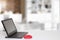 Table top on computer background. Modern portable Laptop with blank screen on white table over abstract blurred home office