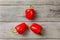 Table top photo - three bright red bell peppers arranged into 3