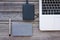 Table top view of a laptop, external hard drive, notebook and a pen,