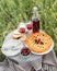 Table top view served with beautiful vintage wine glasses, plates, silver cutlery and tableware, tablecloth, sweet cherry pie and