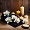 a table topped with candles and flowers on top of a wooden table next to a