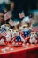 A table topped with small figurines of cats holding american flags. Generative AI image.