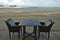 A table with two chairs on lath floor