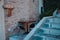 A table with two chairs of a `Ristorante` Restaurant near a staircase in an Italian village Corinaldo, Marche, Italy