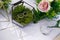 Table for the wedding ceremony decorated with flowers and wedding rings of the newlyweds in a glass box