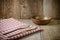 Tablecloth, wooden spoon, fork on wood textured background