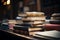 Tableful of books, the library scene softly blurred behind them