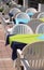 tables of an alfresco cafe with white chairs