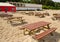 Tables and benches on sea sand and huge cafe tent.