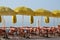 Tables, chairs and beach umbrellas, along the seashore, in Cote