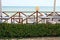 Tables and chairs with a green flower bed on the terrace of the restaurant on the beach