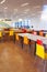 Tables with chairs stand in the classroom