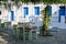 Tables and chairs on street restaurant in Chora on Folegandros Island. Cyclades, Greece