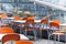 tables and coloured chairs in a street cafe