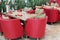 Tables with glasses, soft red armchairs