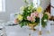 Tables set and flowers for a wedding reception. Arrangement of fresh nature flowers