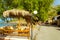 Tables with umbrellas in cafe. Bali, Crete, Greece