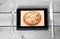 Tablet with an appetizing chicken pizza