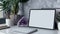 Tablet with a blank screen in a mockup, positioned next to an elegant amethyst gemstone, placed on a pristine white desk