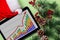 A tablet with a business graph on the desktop. Christmas decorations