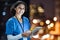 Tablet, city and portrait of a doctor working at night on the rooftop of the hospital building in city. Medical, lights