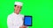 Tablet, cooking and a woman chef on green screen background in studio holding a display with tracking markers. Portrait