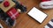 Tablet with copy space on screen lying on table with santa hats and christmas presents