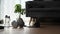 Tablet, dumbbells and bottle of water on wooden floor in living room.