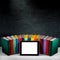 Tablet with empty screen with colorful books on background with