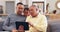 Tablet, father and grandpa with a girl running to a sofa in the living room during a family visit in the home