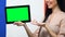 Tablet with green screen in female hands, France flag background, traveling app