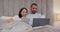 Tablet, laptop or happy couple on social media in bed for communication, web or internet connection. People, talking or