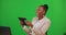 Tablet, laughing business and black woman on green screen in studio isolated on a background. Comedy, technology and
