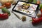 Tablet with Online food delivery app on screen. lifestyle concept