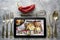 Tablet with Online food delivery app on screen. lifestyle concept