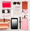 tablet pc, camera, passport, straw bag, notepads, sunglasses, watch, headphones, pills, cosmetics makeup and essentials on white w