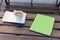 Tablet pc in green cover and cup of tea on wooden table. Relax c