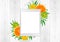 Tablet pc in green fern leaves and citrus fruits; orange, lime;