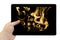 Tablet PC in hand with flames of burning fire background on screen isolated