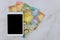 Tablet PC on table banknote with different paper bills currency Venezuelan Bolivar