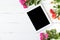 Tablet, roses on the table. Women`s things Fashion womens desk Top view