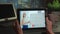 Tablet screen with business woman speaking at conference using whiteboard