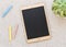 Tablet shaped chalk board on white pebbles background