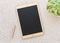 Tablet shaped chalk board on white pebbles background