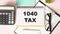 The tablet with text 1040-TAX on business