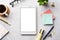 A tablet with white blank screen on an office desk. Flat lay