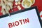 Tablet with word Biotin. Healthy eating.